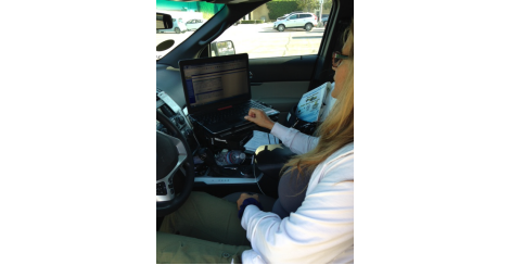 Woman using a laptop computer in a truck