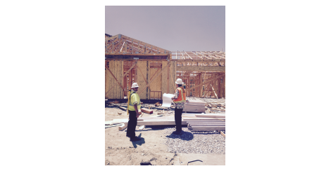 Two men working at a construction site